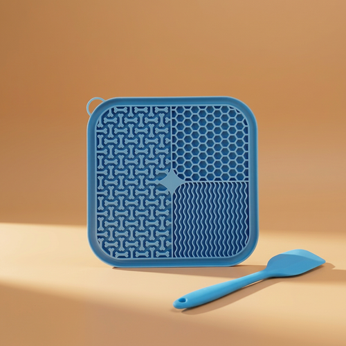 Blue lick mat and spatula with warm background